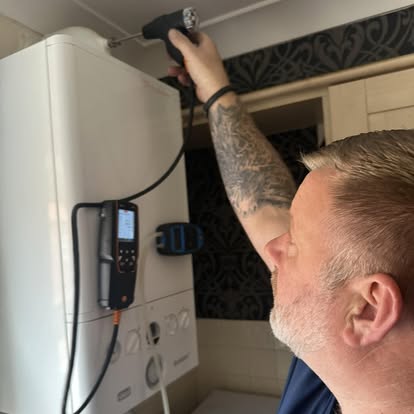 Sparta Gas Safe engineer running a combustion analyser on a domestic gas boiler