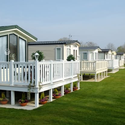 Row of static caravans with white decking on a Lincolnshire holiday park