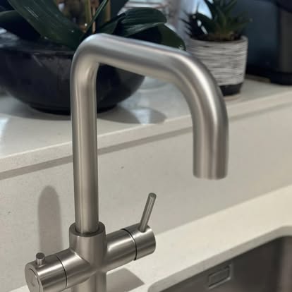 Brushed stainless three-way kitchen mixer tap installed by Sparta
