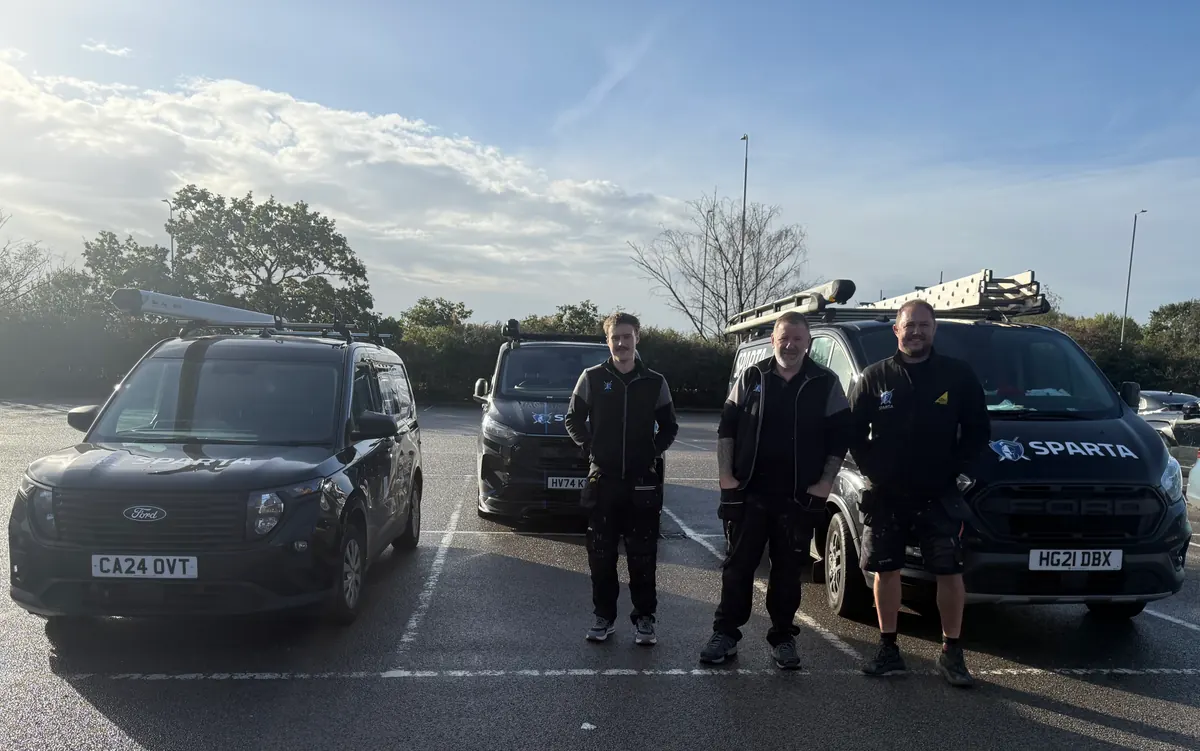 Three Sparta engineers standing in front of their liveried Sparta vans, ready for jobs across Lincoln and Lincolnshire